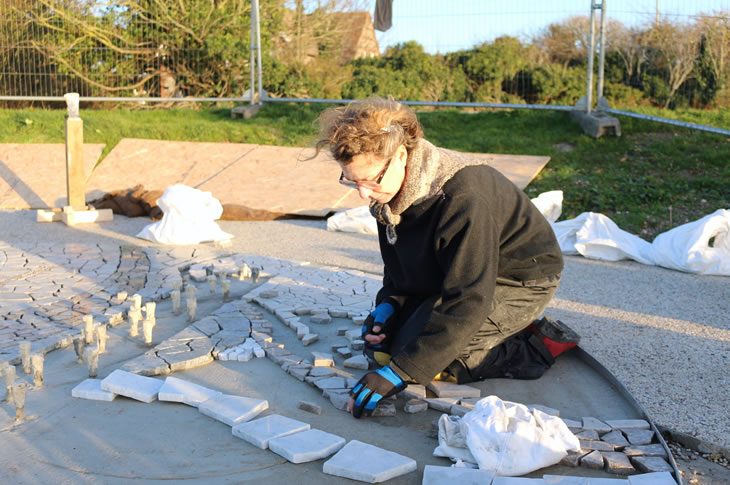 Artist Jane Fordham installing the mosaic tiles on the base of the Shoreham Airshow Memorial