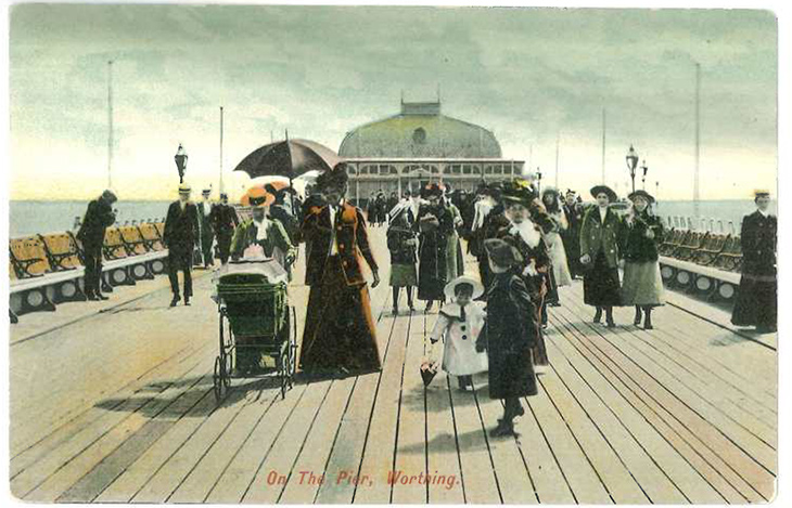 Worthing Pier - people promenading on the pier in their fine clothes