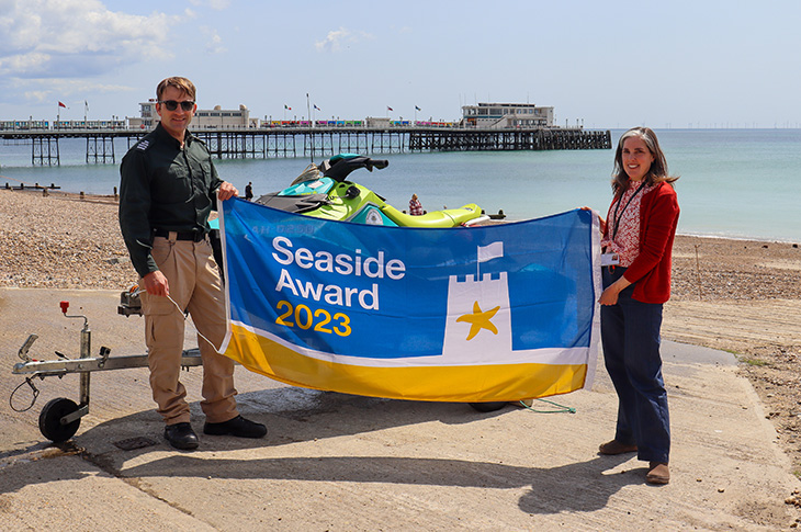 PR23-058 - Rob Dove, Senior Coastal Warden, pictured with Cllr Vicki Wells holding the 2023 Seaside Award flag