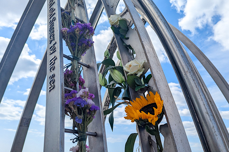 Shoreham Airshow 10th anniversary memorial service - close up of flowers on the memorial by the River Adur