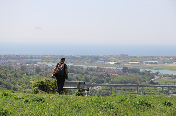 Mill Hill, Shoreham - a man taking a walk on Mill Hill (with the River Adur and Shoreham airport in the distance)