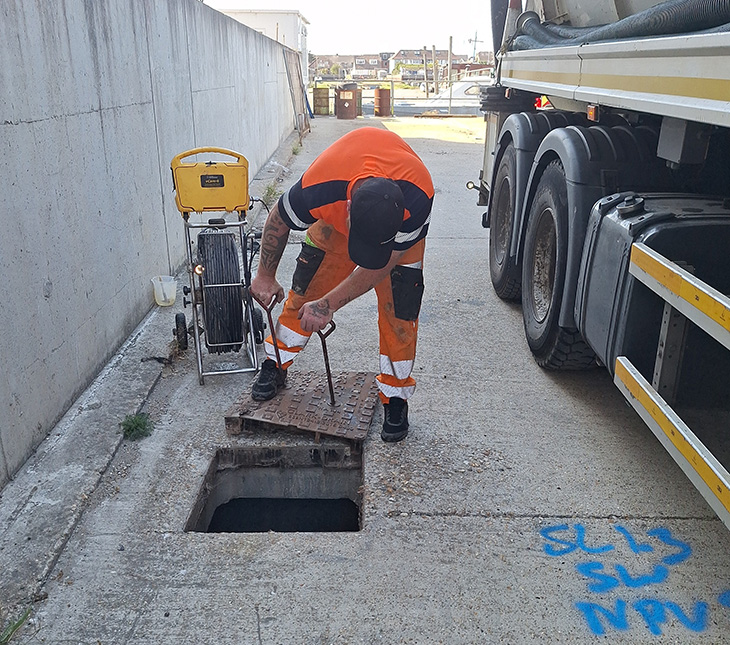 Shoreham flood defences - contractor inspecting the silt build up in drains