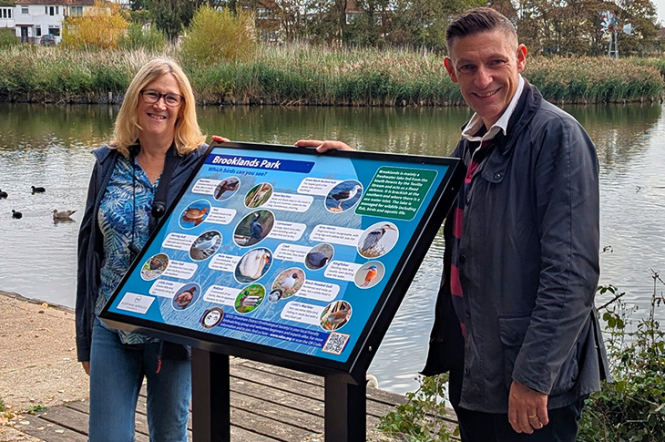 PR26-082 - Jenny Holter, chair of SDOS, with Cllr Martin McCabe & the new bird identification panel at Brooklands Park